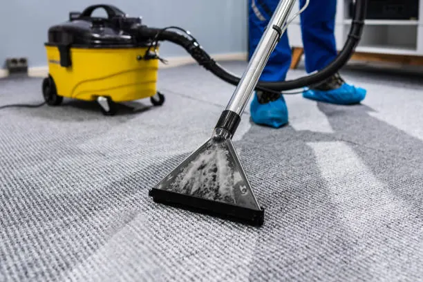 Carpet being vacuumed in an empty room